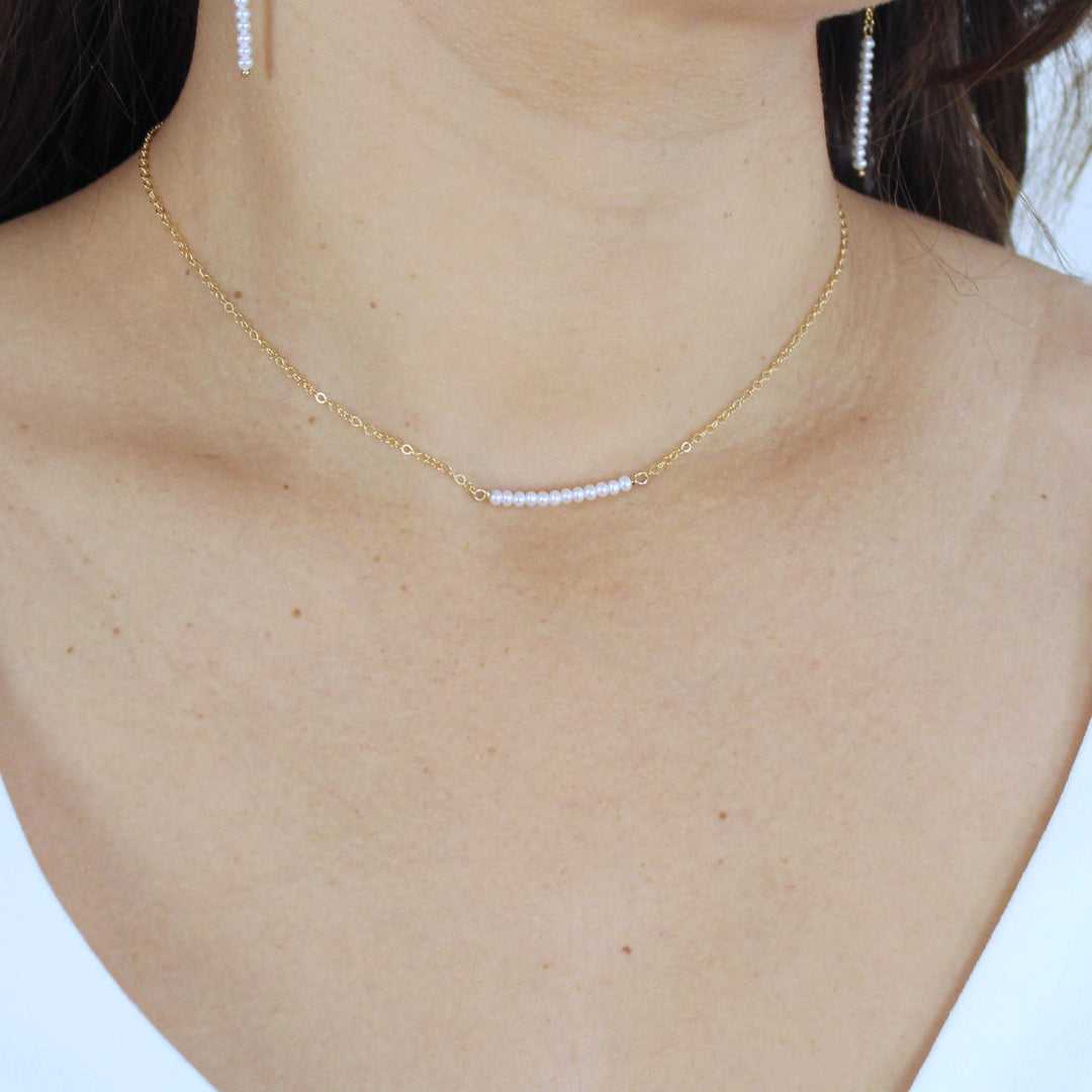 Skinny Bar Pearl Necklace with delicate pearls on a glimmering chain