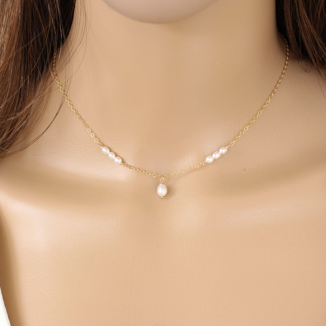 Danielle minimalist Tiny Pearl Necklace showcasing delicate chain with freshwater pearls.